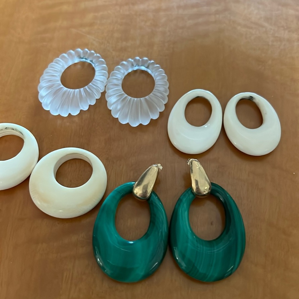 Gold post earrings that has four different hoops that alternate